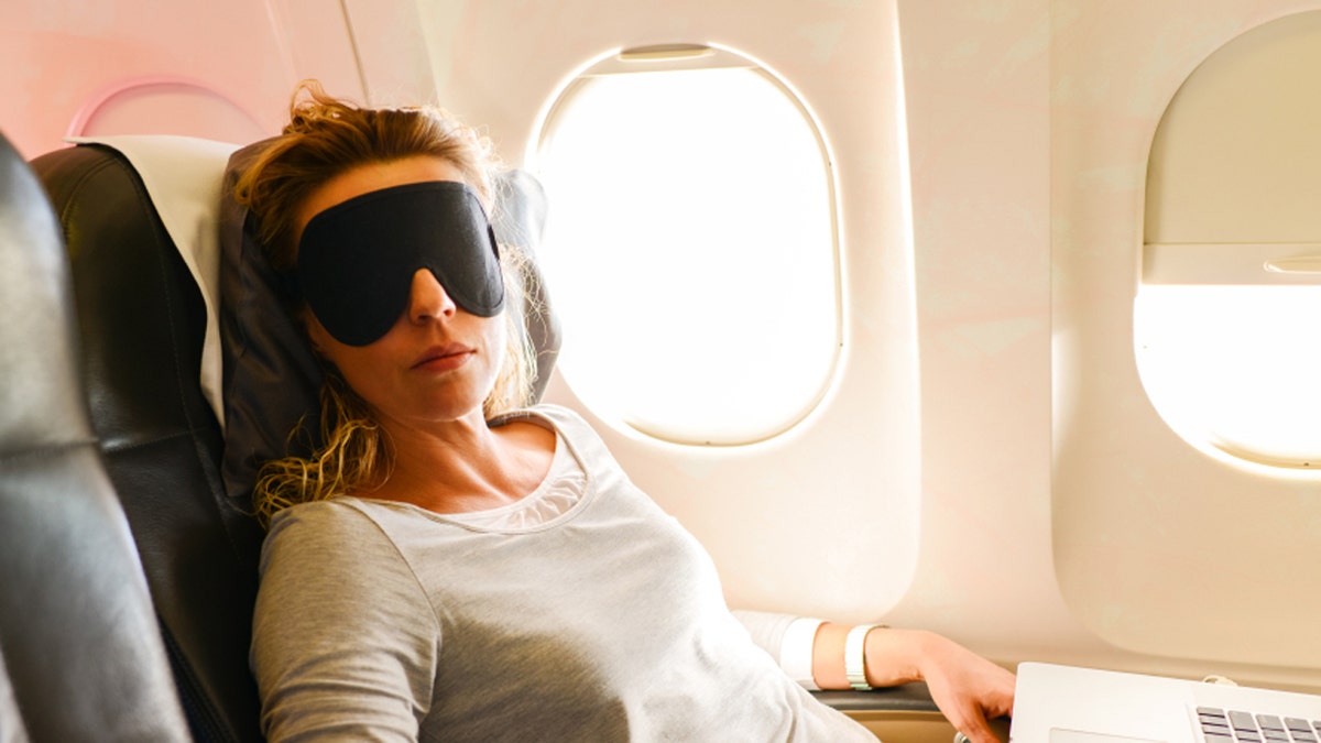 Mature Woman having nap in a plane