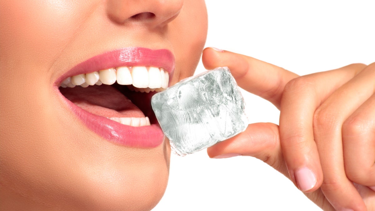 Closeup of beautiful woman biting an ice cube