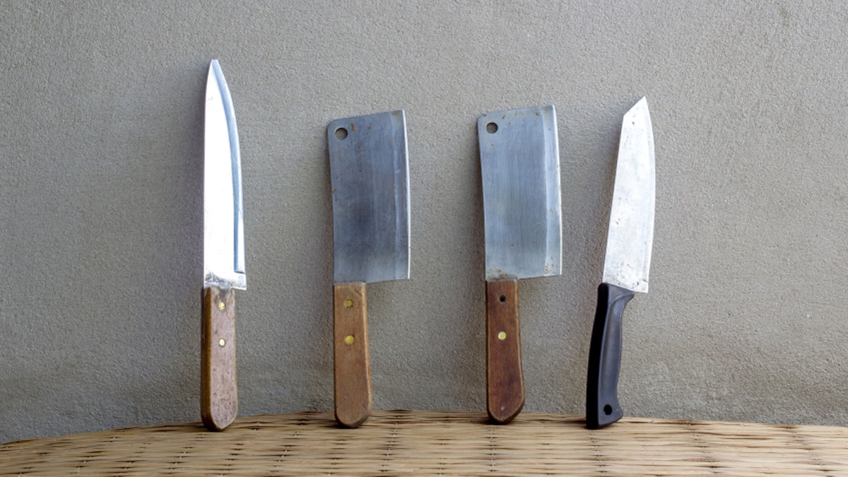 knife cooking set still life on mat weave and concrete wall