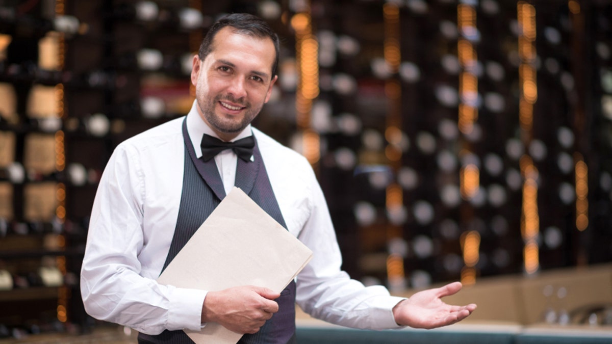 Waiter welcoming people to a restaurant