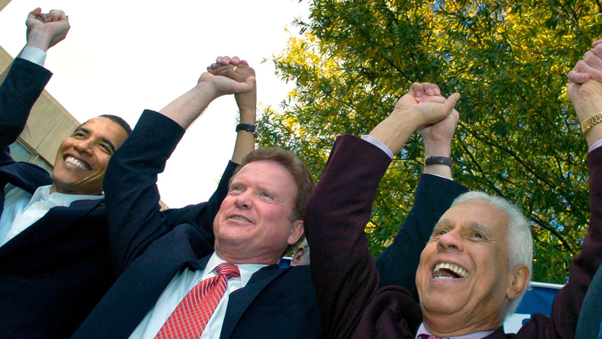 (L-R) U.S. Senator Barack Obama (D-IL), Virginia Democratic senatorial candidate Jim Webb and Richmond Mayor Douglas Wilder join hands at a campaign rally for Webb at Virginia Union University in Richmond, November 2, 2006. REUTERS/Jonathan Ernst (UNITED STATES) - GM1DTVXOPFAA