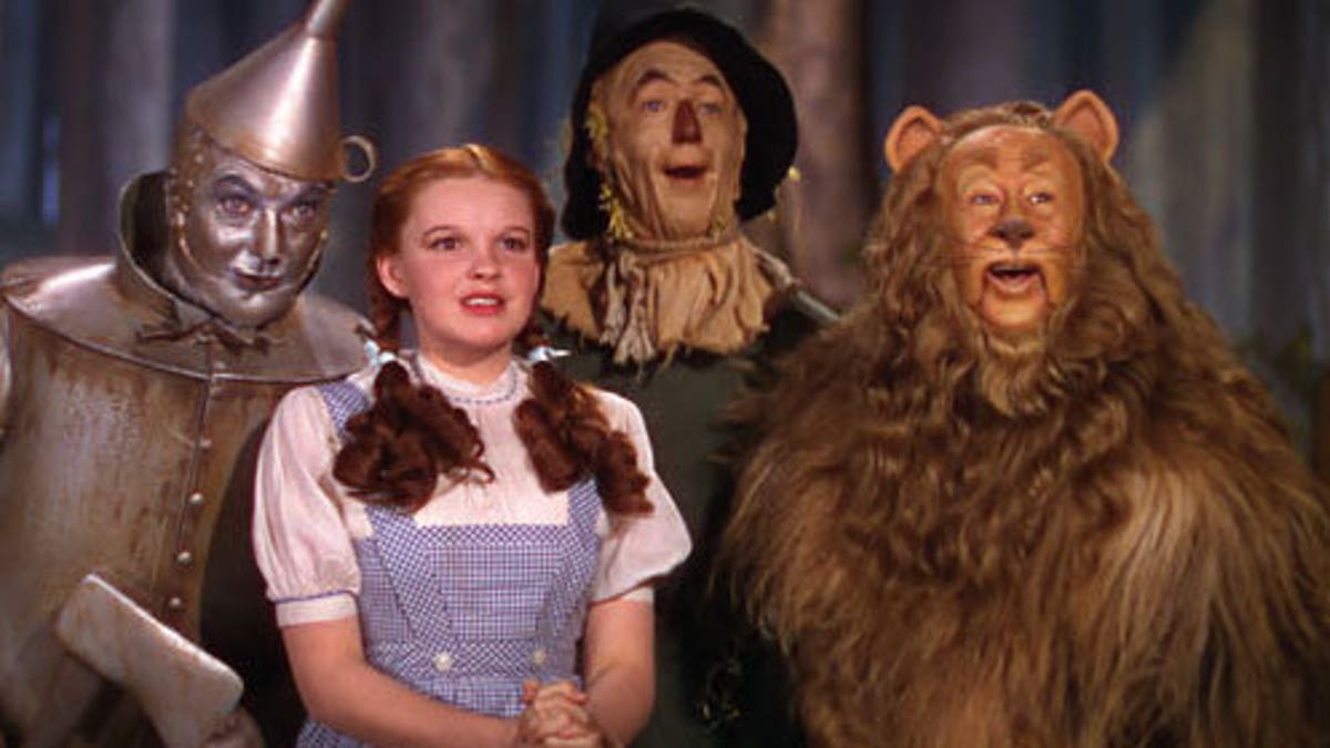 'The Wizard of Oz' screengrab 'The Wizard of Oz' screengrab featuring The Tin Man, Dorothy Gale, Scarecrow and The Cowardly Lion.