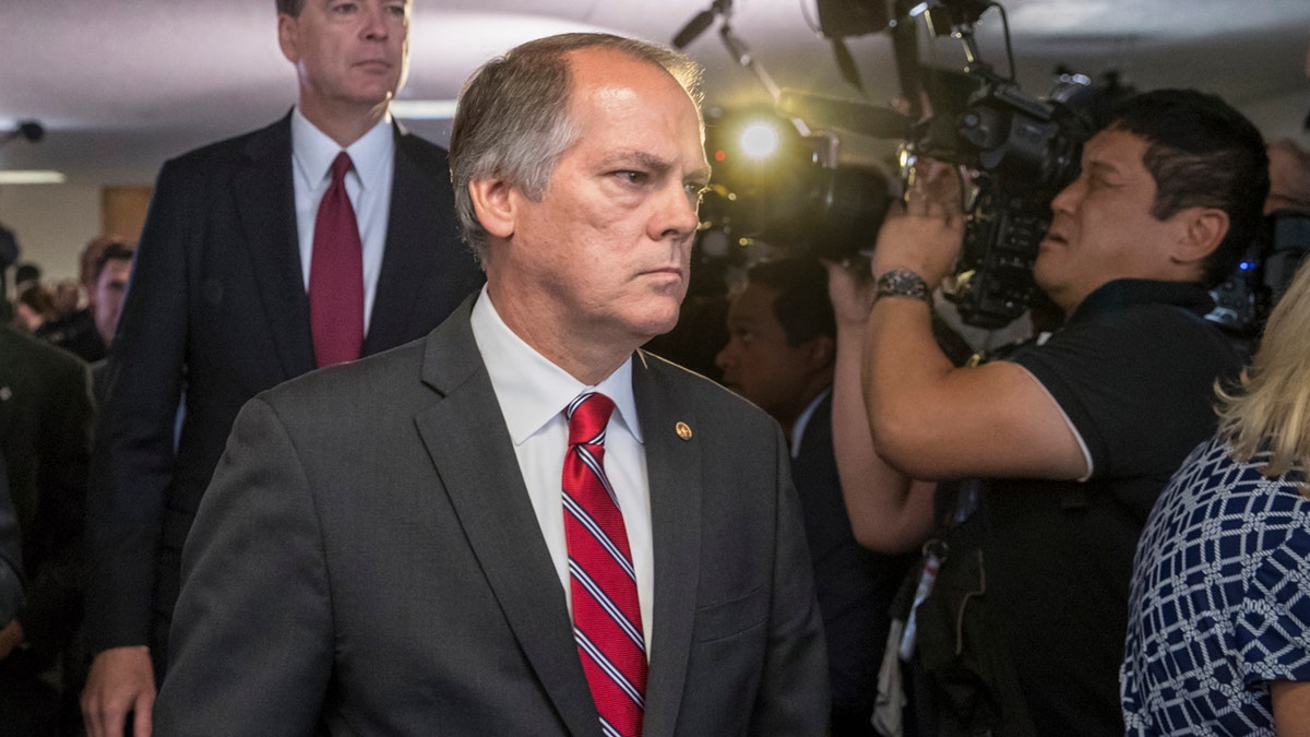 FILE - In this June 8, 2017 file photo, James Wolfe, center, former director of security with the Senate Intelligence Committee, escorts former FBI director James Comey to a secure room to continue his testimony on the 2016 election and his firing by President Donald Trump, on Capitol Hill in Washington. Federal prosecutors are accusing Wolfe with lying to the FBI about contact he had with reporters who covered the committee. (AP Photo/J. Scott Applewhite, file)