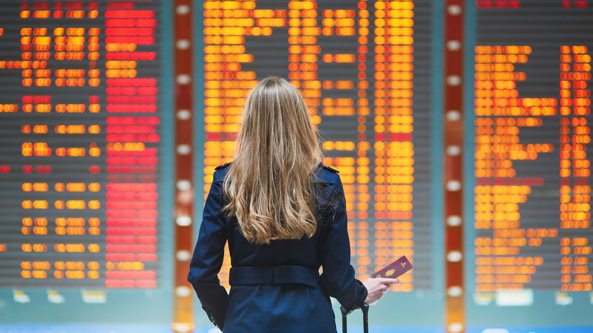 woman at airport travel istock