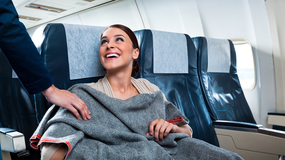 woman blanket plane istock