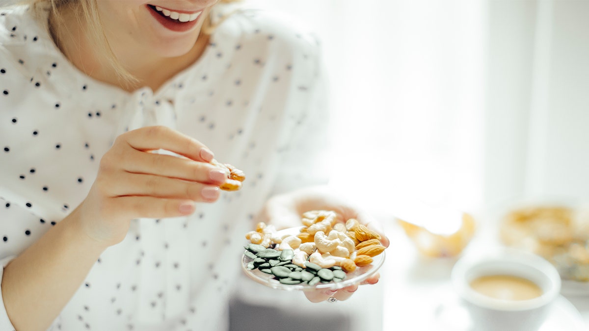 woman eating nuts istock