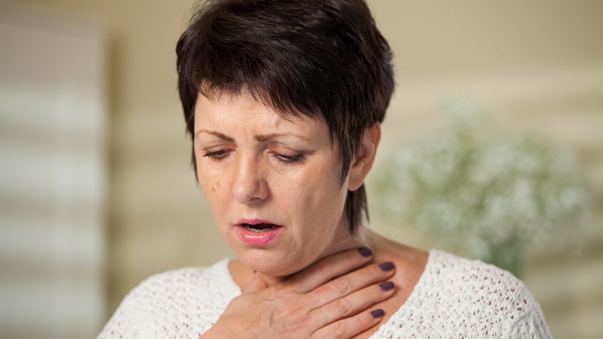 woman having trouble breathing woman sore throat women's health woman sick istock large