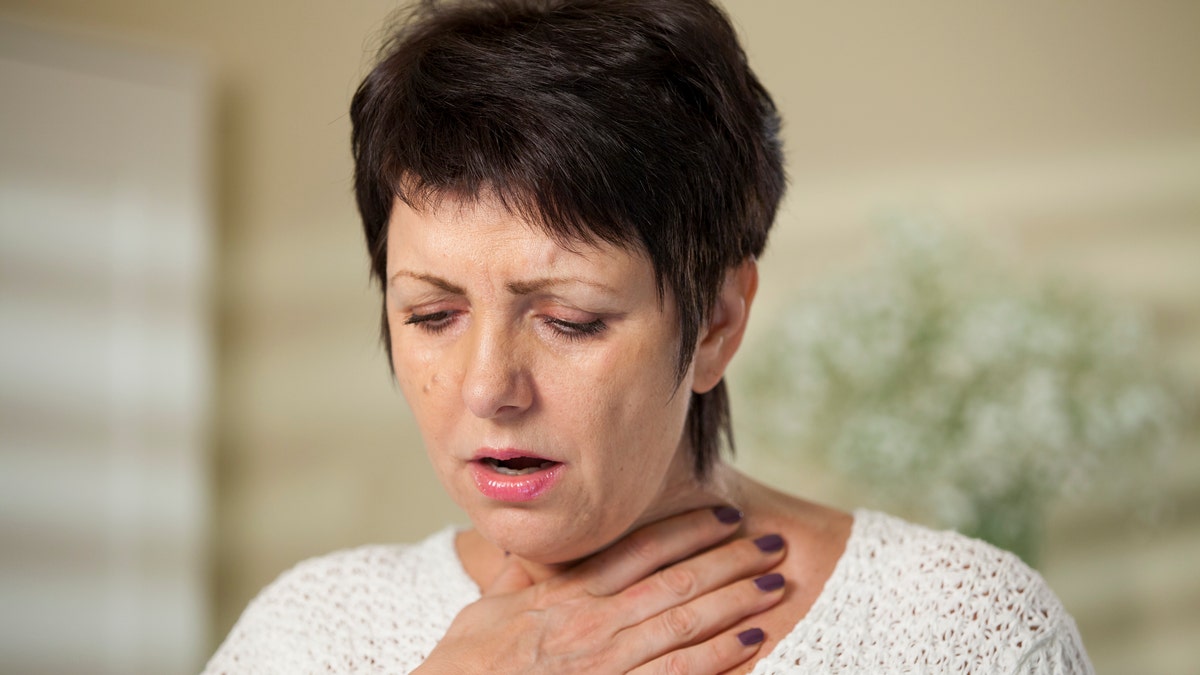 woman having trouble breathing woman sore throat women's health woman sick istock large