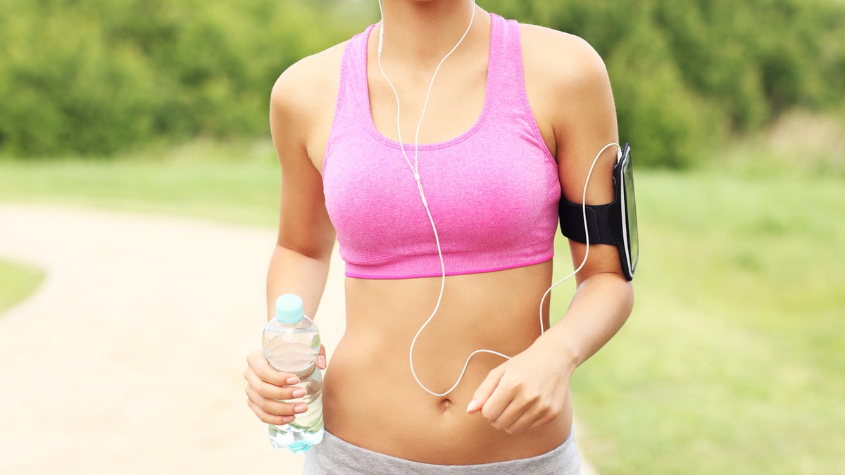 woman in a sports bra walking workout istock medium