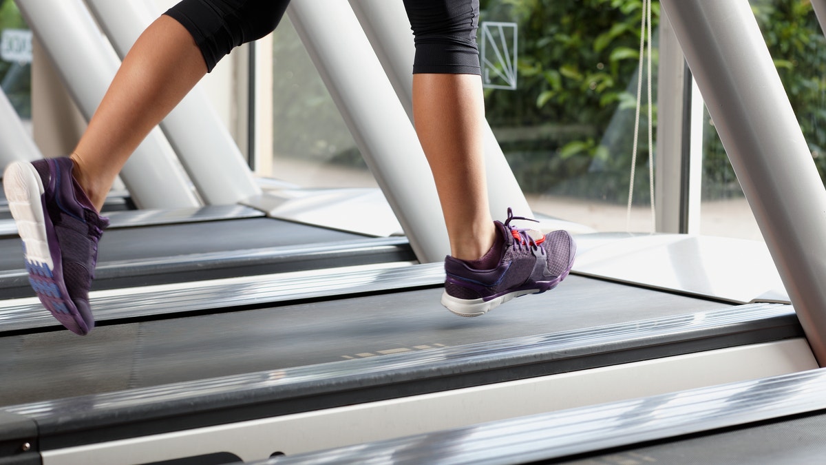 woman on a treadmill feet on a treadmill istock large