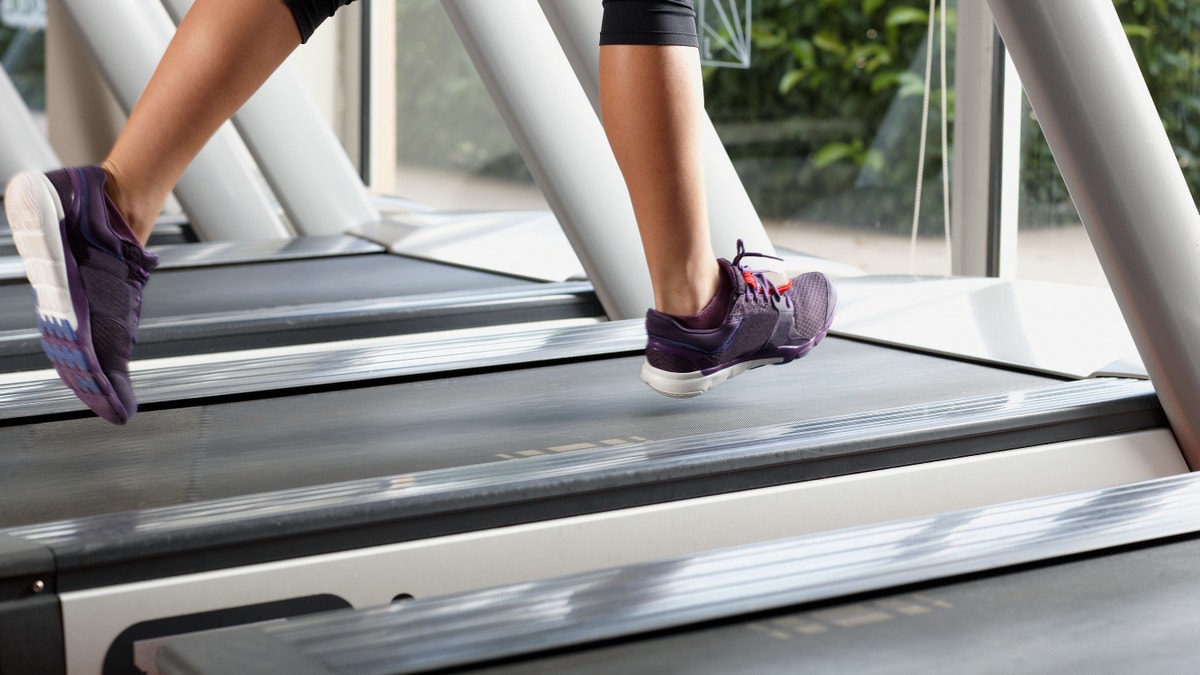 woman on a treadmill feet on a treadmill istock large