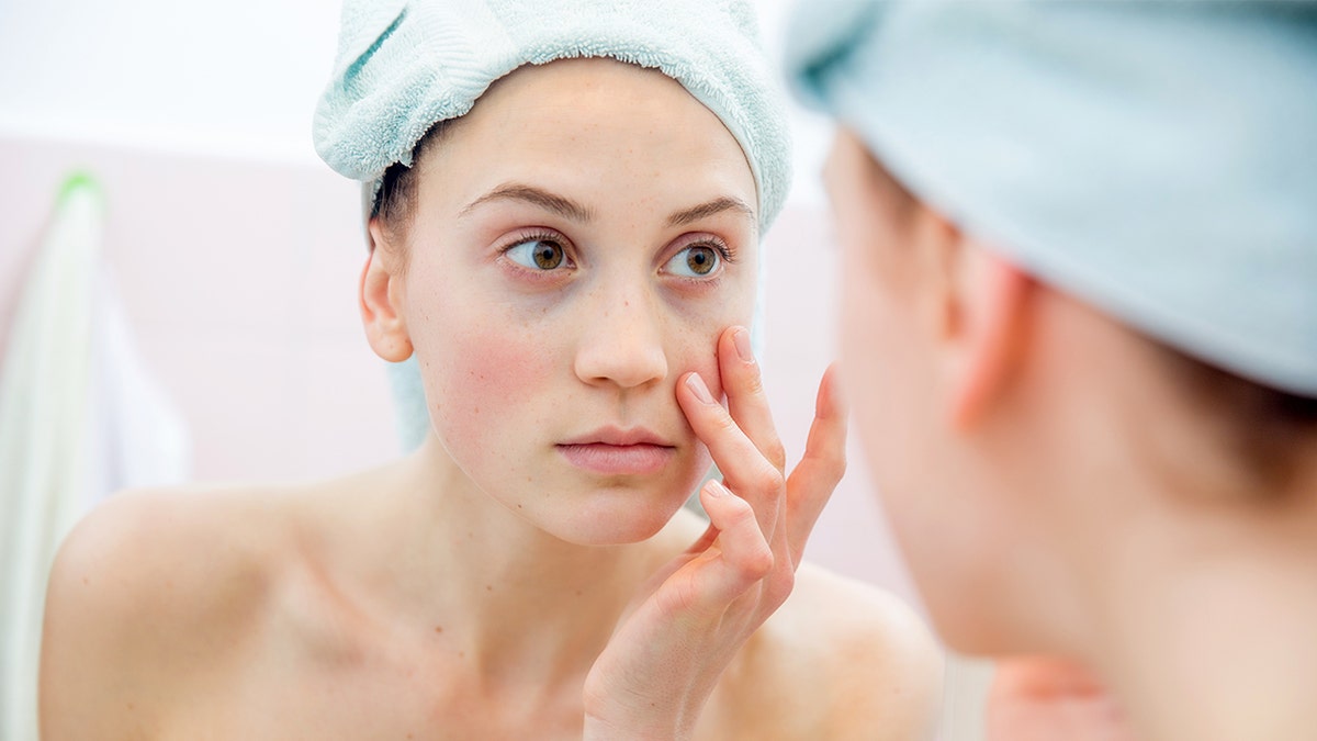 woman staring in mirror