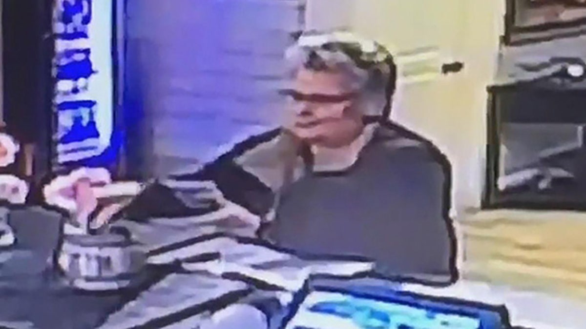 Woman stealing from jar