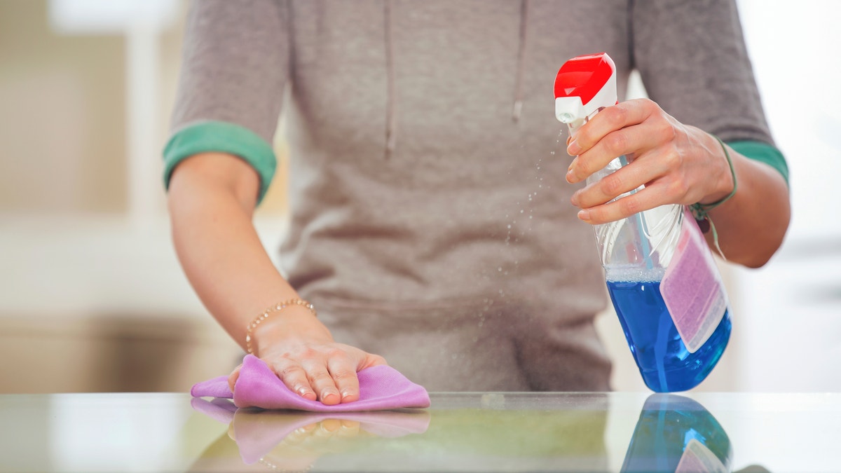 woman using kitchen cleaning product istock
