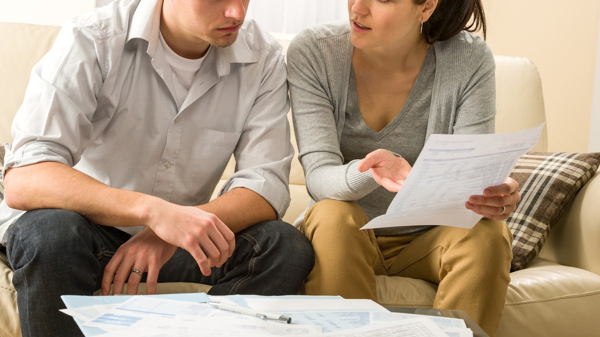 Worried couple talking about their expenses and financial problems