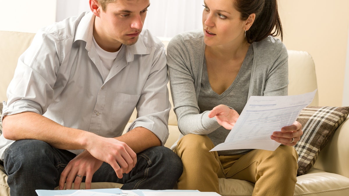 Worried couple talking about their expenses and financial problems