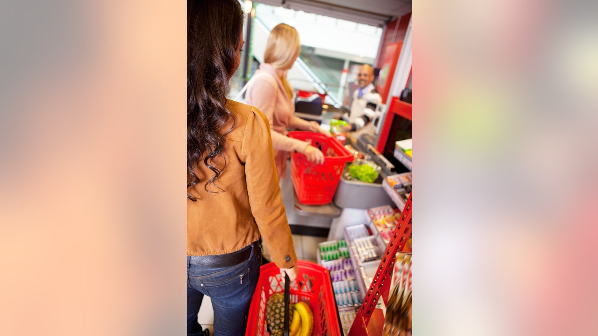 Customers carrying basket while shopping