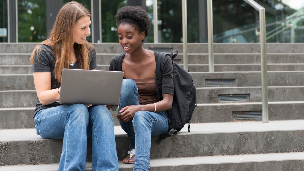 young adult women on the computer istock large