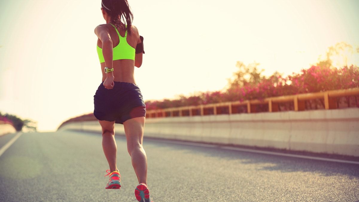 young woman running in sports bra athletic gear istock large