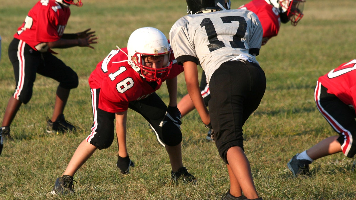 Youth football player in a middle of a game