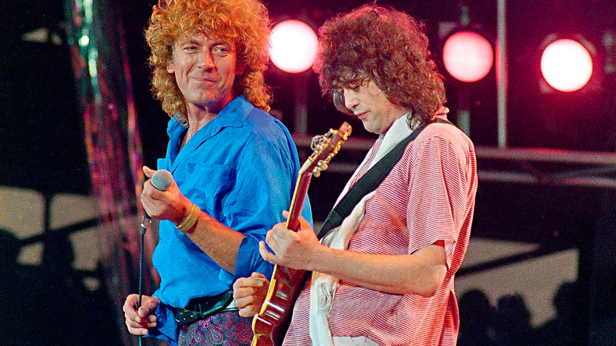 FILE - In this July 13, 1985 file photo, Led Zeppelin bandmates, singer Robert Plant, left, and guitarist Jimmy Page, reunite to perform for the Live Aid famine relief concert at JFK Stadium in Philadelphia. A U.S. appeals court on Friday, Sept. 28, 2018, ordered a new trial in a lawsuit accusing Led Zeppelin of copying an obscure 1960s instrumental for the intro to its classic 1971 rock anthem 