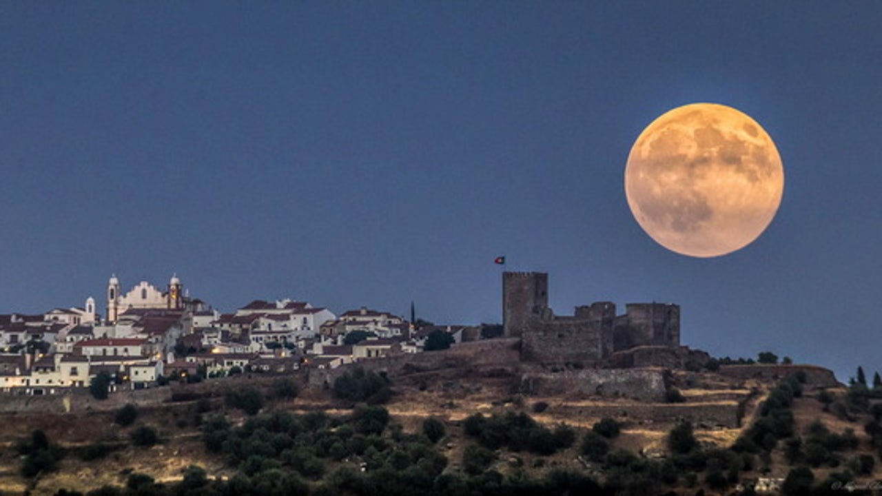 Enormous moon hangs over medieval castle in epic photo | Fox News