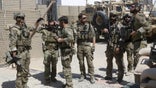 U.S. special forces soldiers talk to each other before they leave their base in Helmand, Afghanistan September 28, 2015.  REUTERS/Omar Sobhani  - RTS5LO2