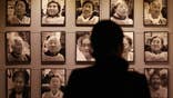 FILE - In this Feb. 3. 2014, file photo, a visitor looks at portraits of late former "comfort women" who were forced to serve for the Japanese troops as a sexual slave during World War II, at the House of Sharing, a nursing home and museum for 10 former sex slaves, in Toechon, South Korea. ‘Comfort women” were present wherever the Japanese Imperial Army invaded and occupied in Asia from the early 1930s through the end of World War II. That aspect of wartime history was kept quiet until the early 1990s, when a South Korean woman came forward, joined by some others, seeking Japanese help and accountability. (AP Photo/Ahn Young-joon, File)