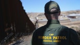 NOGALES, AZ - FEBRUARY 26: A U.S. Border Patrol agent looks along a section of the recently-constructed fence at the U.S.-Mexico border on February 26, 2013 in Nogales, Arizona. The new fencing, which ranges from 18-32 feet high in the Nogales area, allows Border Patrol agents to see through the fence and is harder for immigrants or drug smugglers to scale from the Mexican side. (Photo by John Moore/Getty Images)