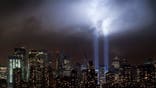 A test of the Tribute in Light rises above lower Manhattan, Tuesday, Sept. 6, 2011, in New York. Four World Trade Center, second from left, is under construction. The memorial, sponsored by the Municipal Art Society, will light the sky on the evening of Sept. 11, 2011, in honor of those who died ten years ago in the terror attacks on the United States. (AP Photo/Mark Lennihan)