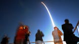 Members of the media photograph the liftoff of a United Launch Alliance Delta IV rocket from Cape Canaveral Air Force Station, Fla. Thursday, Jan. 19, 2012. The rocket is carrying another satellite in the Wideband Global SATCOM series for the Department of Defense. (AP Photo/Florida Today, Craig Bailey) NO SALES