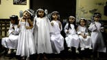 Children dressed as angels wait to perform in a Christmas Nativity at Trinidad neighborhood in Asuncion, Paraguay, Thursday, Dec. 22, 2011. (AP Photo/Jorge Saenz)