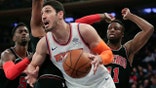 FILE - In this March 19, 2018, file photo, New York Knicks center Enes Kanter (00) drives to the basket against the Chicago Bulls during the first quarter of an NBA basketball game in New York. Kanter informed the Knicks on Friday, June 29, 2018, that he was opting into his contract for next season, rather than becoming a free agent. (AP Photo/Julie Jacobson, File)