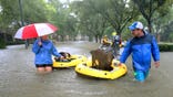 Residents and pets are evacuated from their homes as floodwaters from Tropical Storm Harvey rise, Monday, Aug. 28, 2017, in Houston. (Godofredo A. Vasquez/Houston Chronicle via AP)