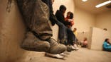 MCALLEN, TX - SEPTEMBER 08:  Women and children sit in a holding cell at a U.S. Border Patrol processing center after being detained by agents near the U.S.-Mexico border on September 8, 2014 near McAllen, Texas. Thousands of immigrants, many of them families and unaccompanied minors, continue to cross illegally into the United States, although the numbers are down from a springtime high. Texas' Rio Grande Valley area is the busiest sector for illegal border crossings into the United States.  (Photo by John Moore/Getty Images)