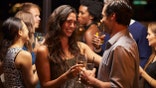 Couples Dancing And Drinking At Evening Party