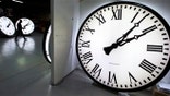 Tom Liberatore, a materials purchasing manager, walks past clocks being tested prior to shipping at the Electric Time Company in Medfield, Mass., Thursday, March 10, 2016. Most Americans will lose an hour of sleep this weekend, but gain an hour of evening light for months ahead, as Daylight Saving Time returns this weekend. The time change officially starts Sunday at 2 a.m. local time. (AP Photo/Charles Krupa)