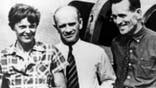 FILE - In this file photo taken on or about July 2, 1937, American aviator Amelia Earhart, left, and her navigator, Fred Noonan, right, pose beside their plane with gold miner F.C. Jacobs at Lae, New Guinea just before Earhart and Noonan took off in a flight to Howland Island on July 2, during which they disappeared somewhere in the Pacific. (AP Photo, File)