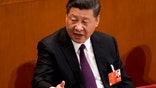 Chinese President Xi Jinping talks to leaders after being formally re-elected to a second term as China's President during a plenary session of China's National People's Congress at the Great Hall of the People in Beijing, Saturday, March 17, 2018. Xi was reappointed Saturday as China's president with no limit on the number of terms he can serve. The ceremonial National People's Congress voted unanimously for Xi's second five-year term as president. (AP Photo/Andy Wong)