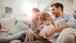 Close up of a happy young family playing at home