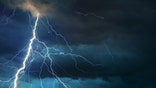 Fork lightning striking down during summer storm.