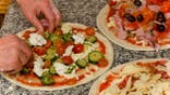 cook's hands are making pizza
