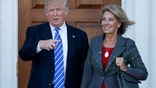 FILE - In this Nov. 19, 2016 file photo, President-elect Donald Trump and Betsy DeVos pose for photographs at Trump National Golf Club Bedminster clubhouse in Bedminster, N.J. Trump has chosen charter school advocate DeVos as Education Secretary in his administration. (AP Photo/Carolyn Kaster, File)