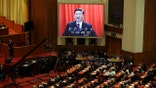 Chinese President Xi Jinping is displayed on a big screen as he delivers a speech at the closing session of the annual National People's Congress in the Great Hall of the People in Beijing, China, Tuesday, March 20, 2018. (AP Photo/Ng Han Guan)