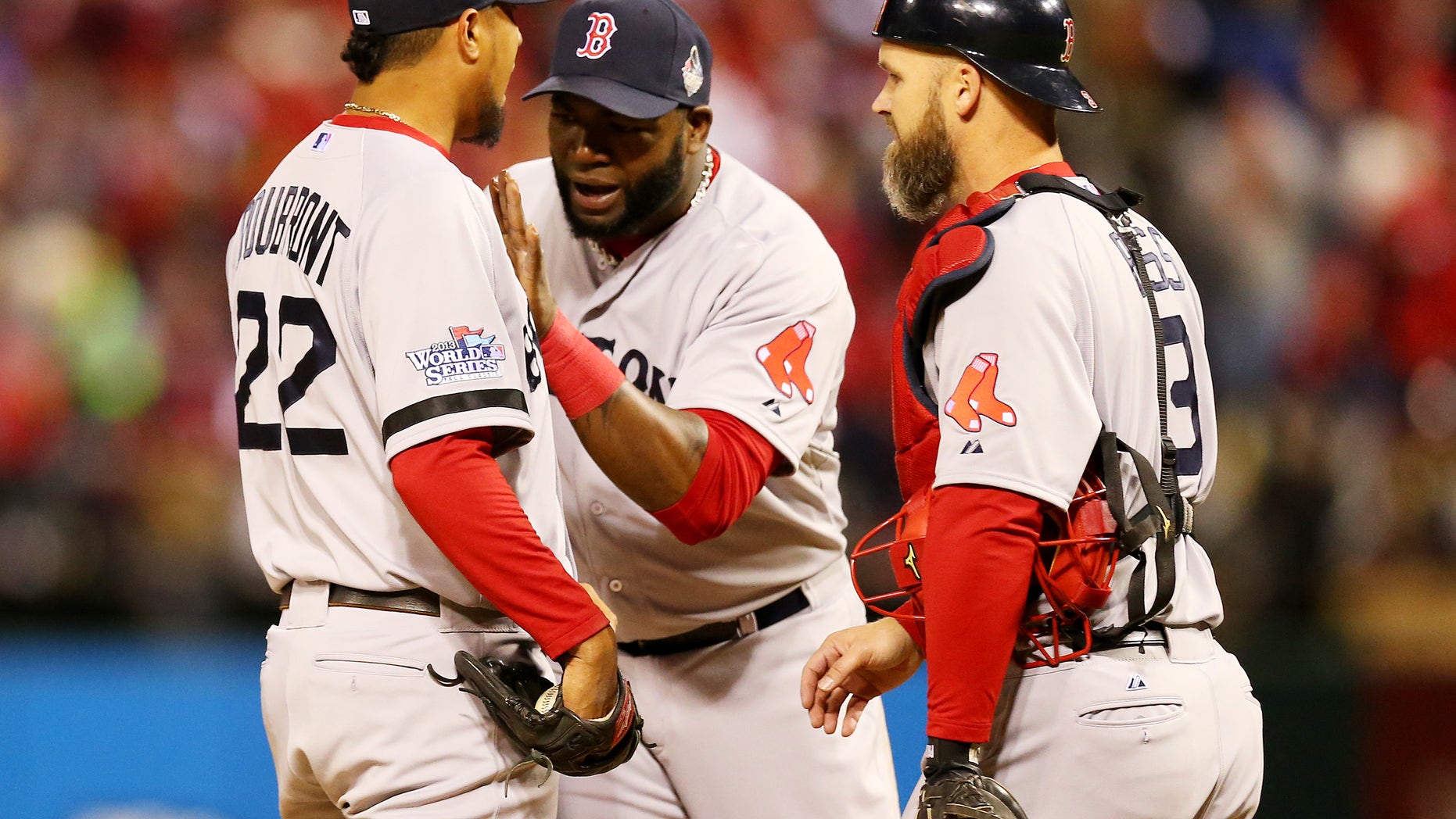 Boston Red Sox players waving to teammates in dugout from second