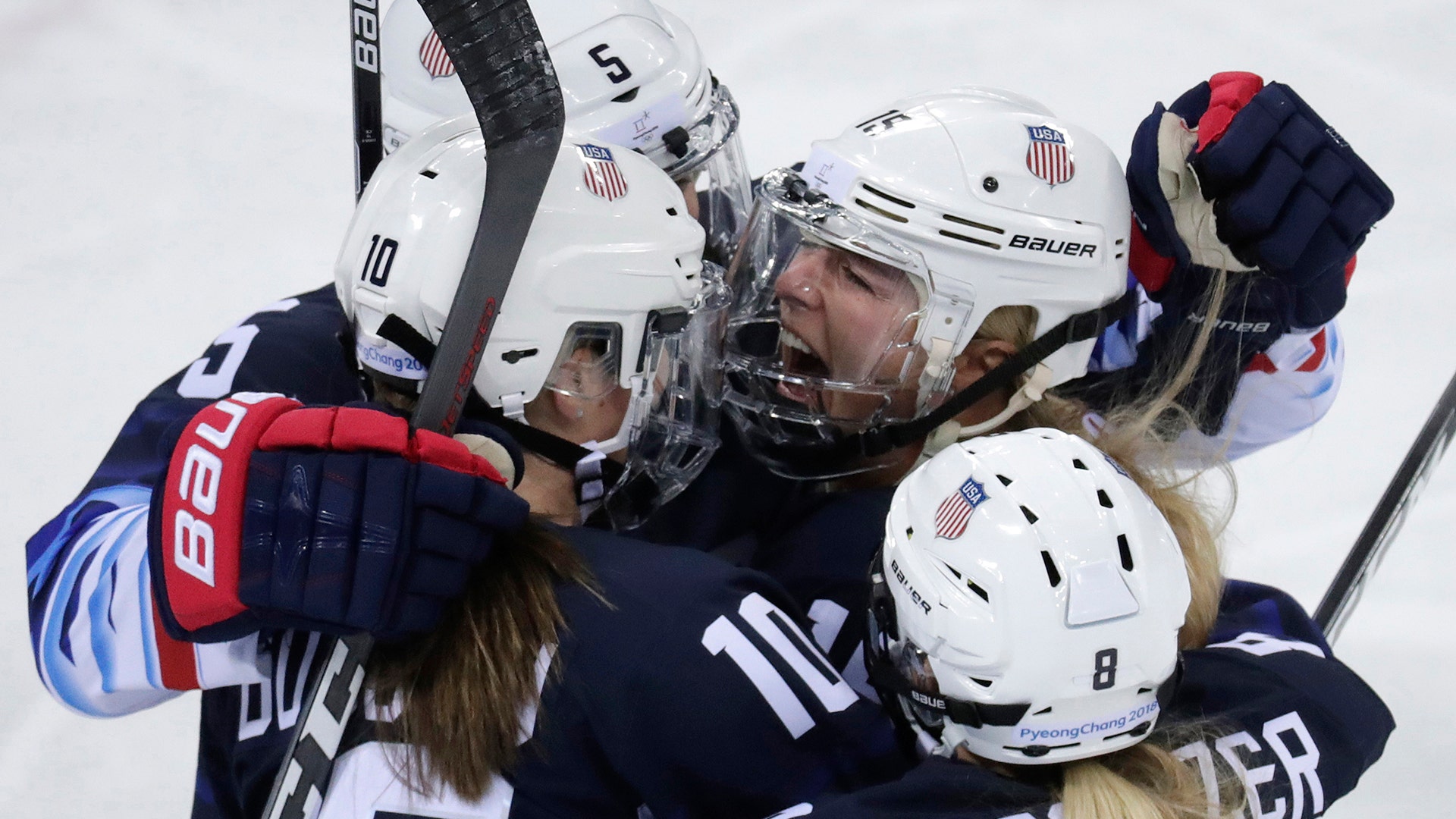 Gigi Marvin of the United States, with her teammates after scoring a goal against Finland in their ice hockey game at the 2018 Winter Olympics