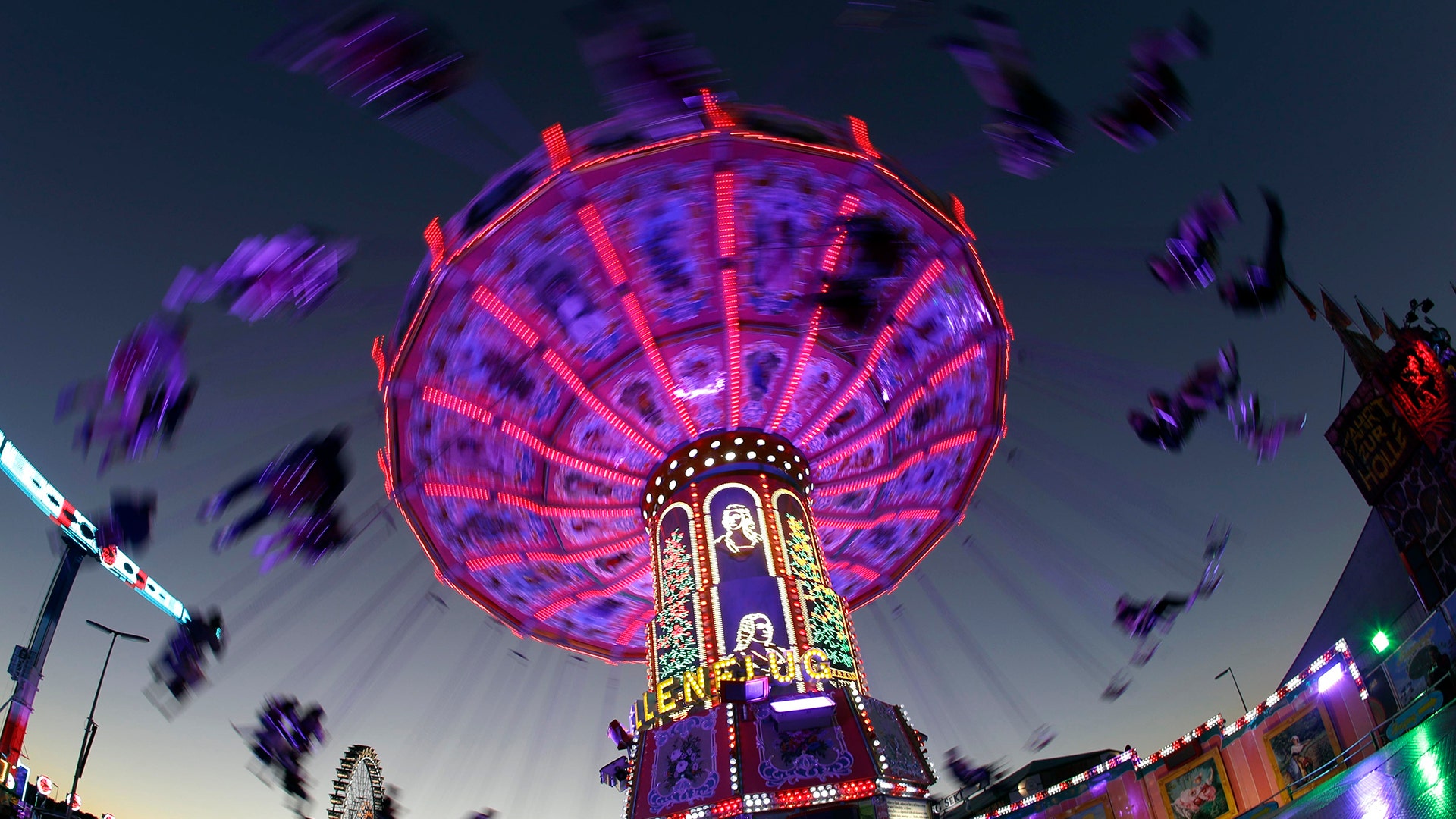 People enjoy a swing ride at the 185th Oktoberfest beer festival in Munich, Germany, September 27, 2018