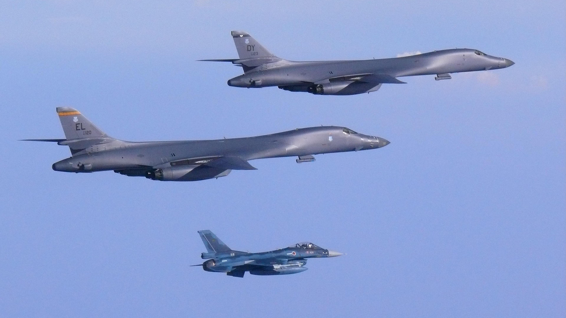 Two USAF B-1B Lancers accompany a Japan Air Self-Defense Force F-2 fighter jet into Japanese airspace and over the Korean Peninsula