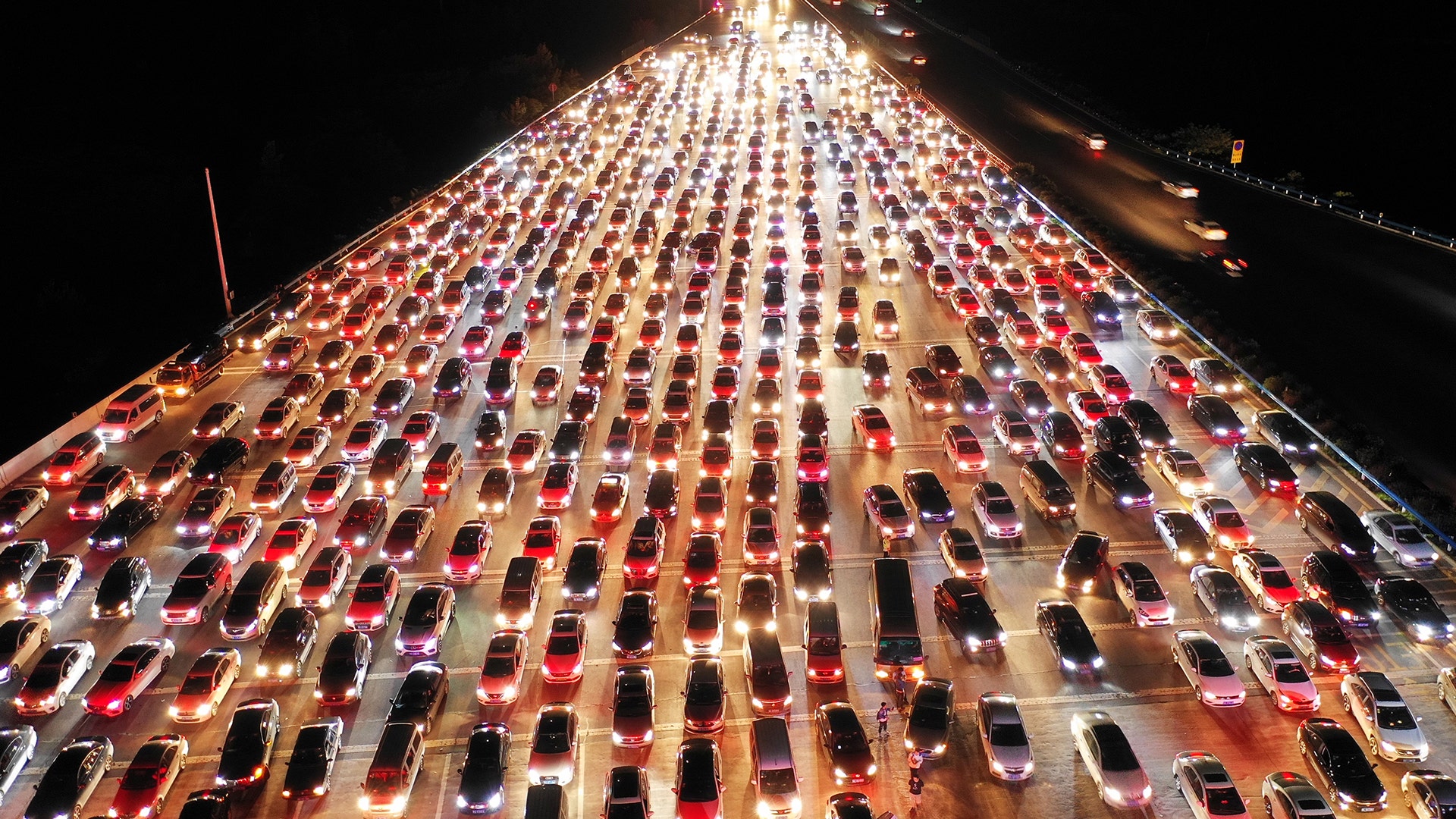 Vehicles are seen jammed on a express way near a toll station in Zhengzhou, Henan province, China, September 24, 2018