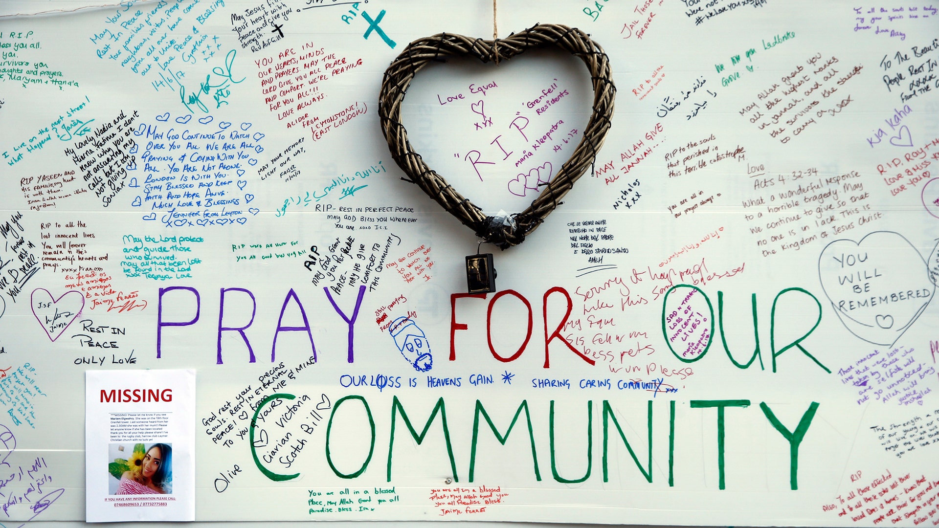 Messages of support for those affected by the massive fire in Grenfell Tower are displayed on a wall near the tower in London